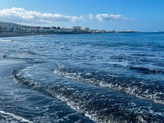 Small ocean waves on the beach. Tenerife. Canarian Island. Amazing sky.