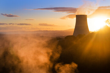 Photographic view of the steam cooling chimney at sunset