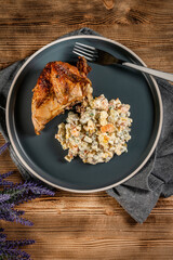 Roast chicken served with russian traditional salad.