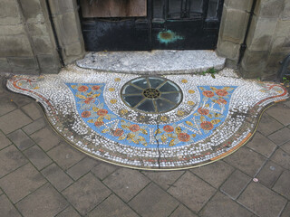 entrance of a house with a decorated mosaic floor
