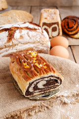Poppy seed cake and breads on the table.