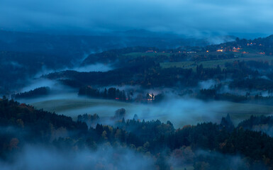 evening fog over meadows in a mountain valley
