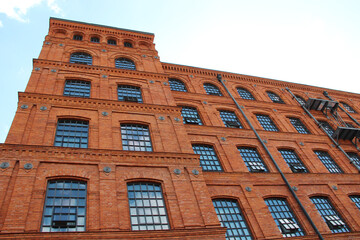 Facade of red brick factory building. Old factory in Lodz