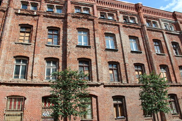 Facade of old brick building. Old building with windows in Polish city of Lodz