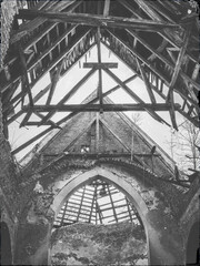 view to cross in wooden frame under roof in abandoned church