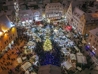 Drone shot of the Christmas Market in Tallinn's old town townhall square on a busy afternoon,...