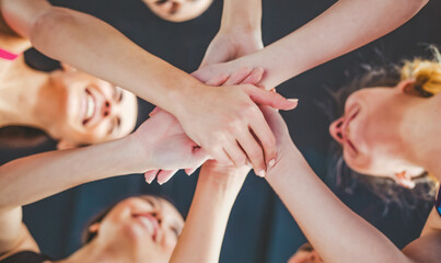 Business teamwork group of young women hands. Stacked huddle together. Unity international