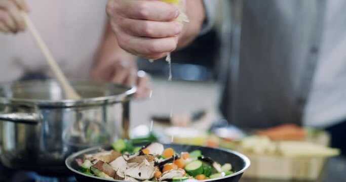 Hands of couple, cooking in kitchen with lemon, ingredients and healthy food in pan for nutrition, marriage and diet. Vegetables in pot, hand of man helping woman with meal prep and dinner in home.