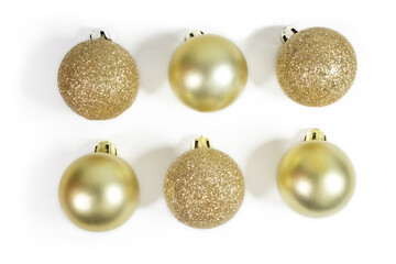 Close up of a set of glitter gold and matte glossy christmas ornament, isolated, top view, flat...