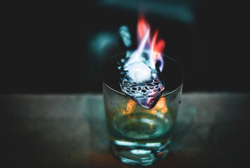 Making green absinthe with sugar and fire