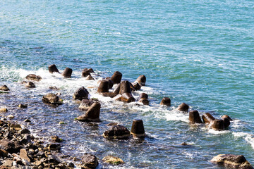 Naklejka premium travel to Georgia - Tetrapods breakwaters on Black Sea coast on border between Turkey and Georgia in Sapri village on sunny autumn day
