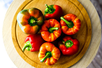 Colorful peppers on the wooden board