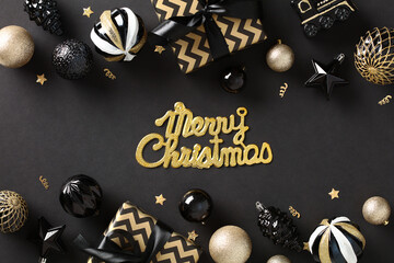 Merry Christmas greeting card with gold baubles, chic gift boxes, decorations, confetti on black background. Elegant Xmas banner design.