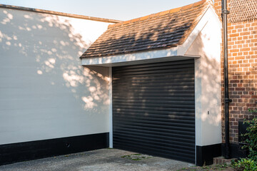 White garage and automatic black garage door - Powered by Adobe