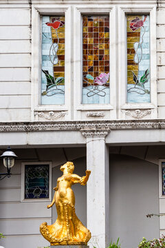 Batumi, Georgia - September 16, 2023: golden statue and stained glass windows of oleg galogre hotel on Piazza Square in Batumi city.