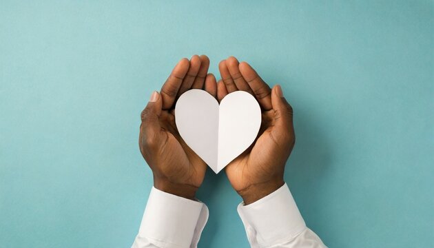 first person top view photo of valentine s day decorations girl s hands in white stylish shirt holding white paper heart on pastel blue background with blank space