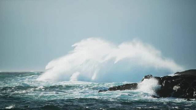 Mighty wave crashing into the rocks on the coastline. Dangerous sea during windy day at Vesterålen, Norway.