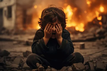 Foto op Aluminium a little boy is crying covering his face with his hands against the backdrop of a war explosion © InfiniteStudio