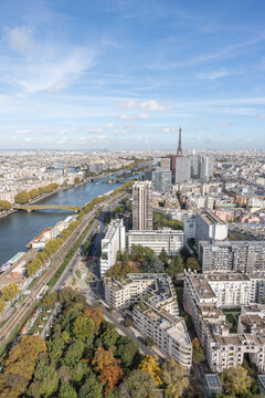 Beautiful aerial view of the city of Paris, taken from the Generali Balloon, Parc André-Citroën in the 15th arrondissement. We can see the Seine river, the Eiffel Tower and a lot of buildings.