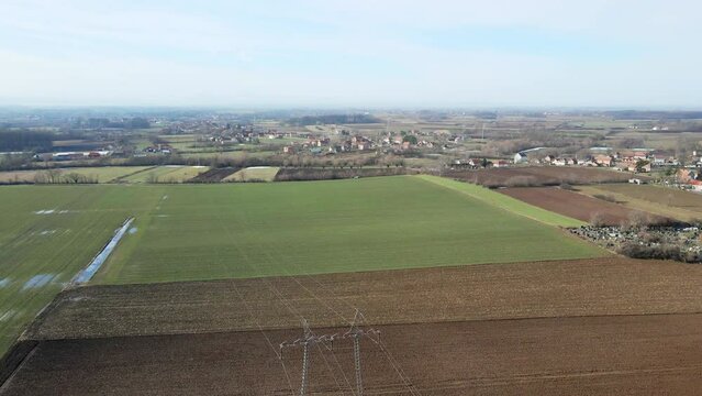 Aerial view of green agricultural fields with puddles in Ub, Serbia