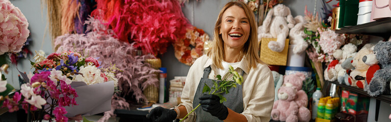 Female decorator creating beautiful bouquet at table. Lifestyle flower shop - Powered by Adobe