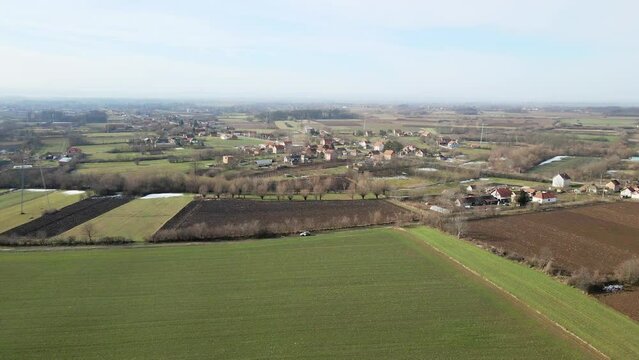 Drone footage of green agricultural fields with puddles in Ub, Serbia