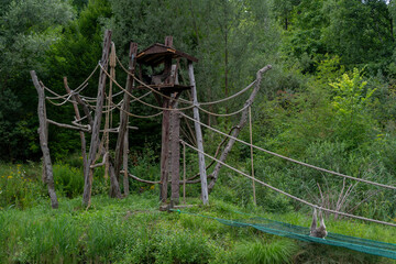 Fototapeta na wymiar a wooden structure with ropes for monkey entertainment in the park