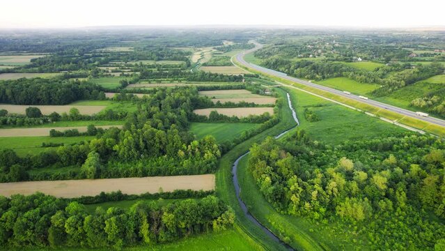 Drone flies around river Ub surrounded by greenery and agricultural fields in Serbia