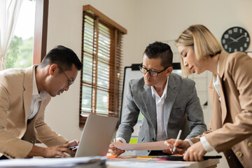 Asian businessmen, women and men Talk about new projects, presents at home office.