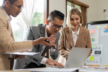 Asian businessmen, women and men Talk about new projects, presents at home office.