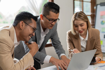 Asian businessmen, women and men Talk about new projects, presents at home office.