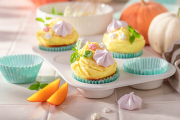 Traditionally pumpkin muffins with cream, meringues and sprinkles.