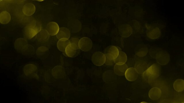 Bokeh shining colorful particles. Shimmering Glittering Particles loop animation with black background