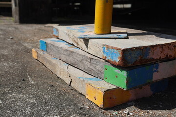 Three pieces wood of steel scaffolding supports in the construction area.