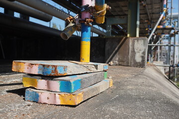 Three pieces wood of steel scaffolding supports in the construction area.