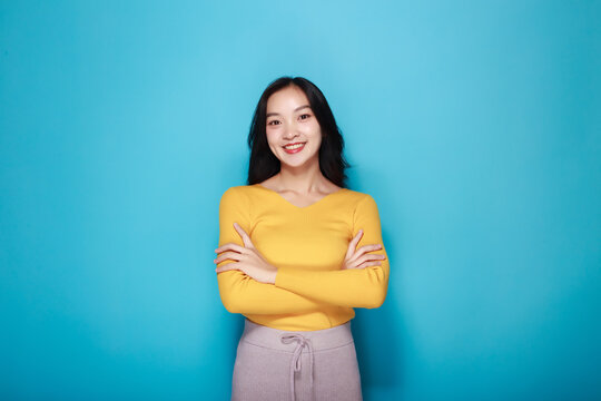 Portrait of a friendly young woman smiling happily, Portrait of a beautiful young woman in a pink background, happy and smile, posting in stand position.