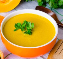 Pumpkin soup served on the table in bowl