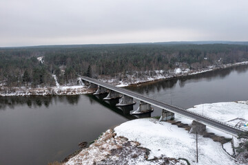 Aerial view of the bridge over the river and forest in a cloudy day, Lithuania