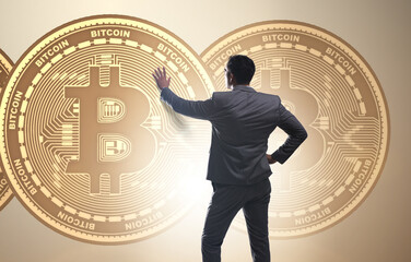 Businessman walking towards bitcoins in cryptocurrency blockchai