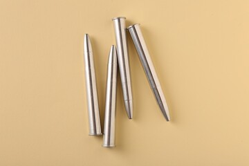 Many metal bullets on yellow background, flat lay