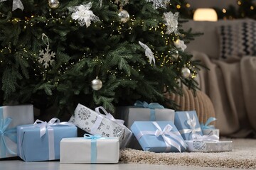 Many different gifts under Christmas tree on carpet indoors