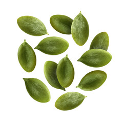 Peeled pumpkin seeds falling on white background