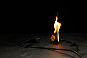 An electrical plug fire is caused by a short circuit of electrical current. Concept of prevention...