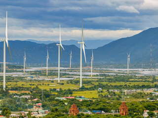 Naklejka premium Wind Turbines And Solar Panels At Sunset - Renewable Energy Concept. Ninh Thuan, Vietnam