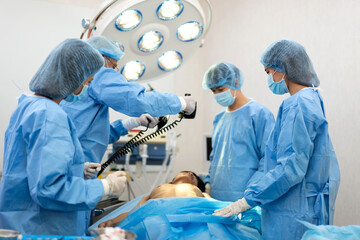 Professional anesthesiologist doctor team and assistant preparing patient to gynecological surgery...