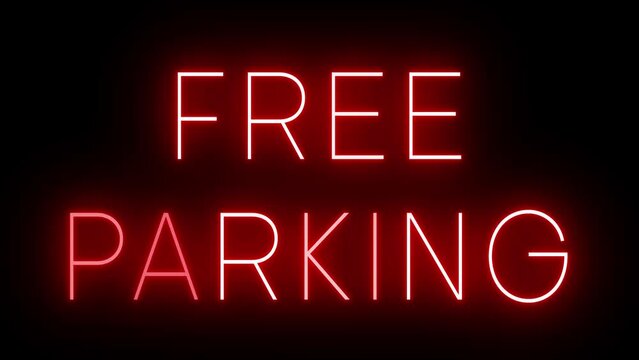 Flickering red retro style neon sign glowing against a black background for FREE PARKING