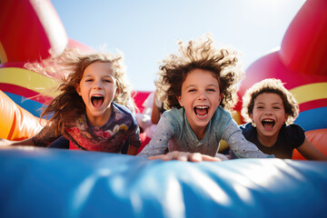 happy Kids on the inflatable bounce house - obrazy, fototapety, plakaty