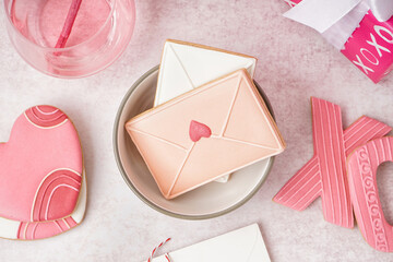 Composition with tasty cookies and glass of drink on light background. Valentine's Day celebration