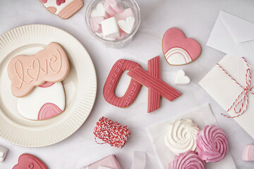 Composition with sweet cookies, marshmallows and envelopes on light background. Valentine's Day celebration
