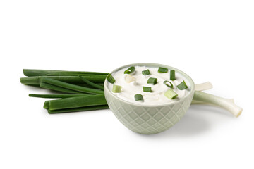 Bowl of tasty sour cream with green onion on white background